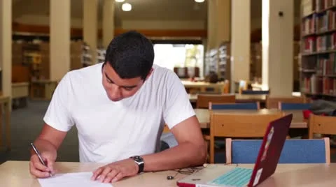 Multi-ethnic university student working in the library Stock Footage 22341185