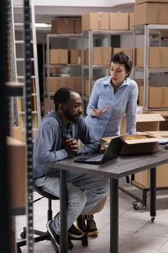 Multi ethnic workers analyzing client delivery data on laptop computer after 写真素材