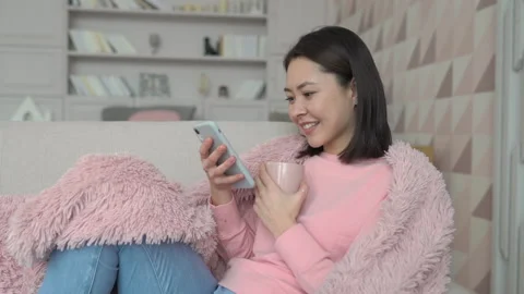 Multi ethnic young asian lady using smart phone surfing social media, checking Stock Footage 151594428