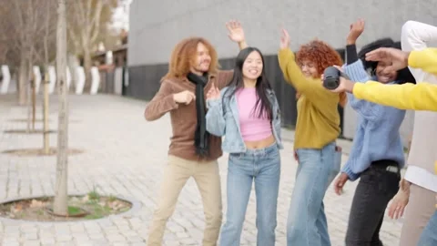 Multi-ethnic young friends dancing in the street Stock Footage 262228740