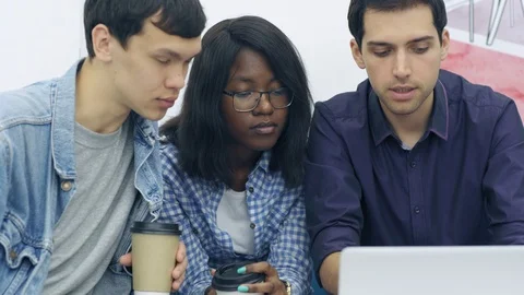 Multi-ethnic young professionals discussing corporate presentation Stock Footage 105189684