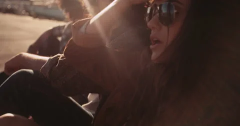 Multi-ethnical hipster friends resting out of their van at sunset Stock Footage 61386868