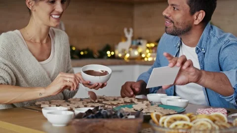 Multi ethnicity couple decorating sweet cookies at home during the Christmas 스톡 동영상 218772710
