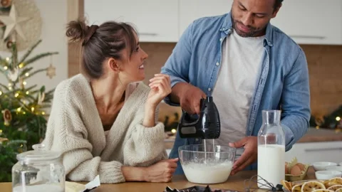 Multi ethnicity couple making a cake in Christmas time Stock-Footage 218804791