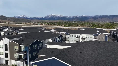 Multi-family apartment complex with full parking lot sits on desert hillside in Stock-Footage 338955656