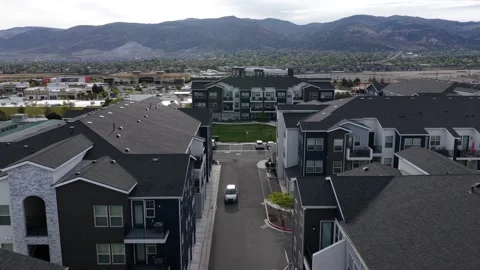 Multi-family apartment complex spans narrow streets in Reno, Nevada, with dark Stock Footage 338419389