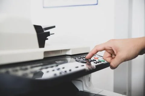 Multi-function device in office center, worker sets the scan options for send Fotos Stock