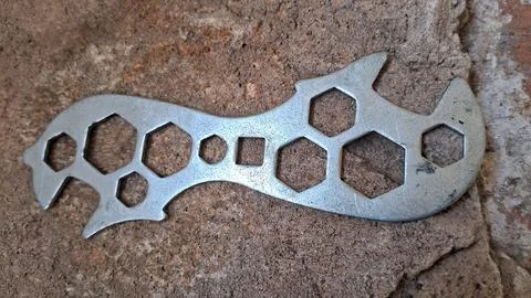 Multi-function metal wrench tool. Steel pocket spanner for mechanical repair and Stock Photos