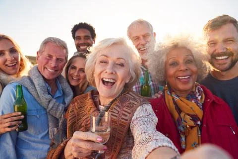 Multi-Generation Adult Family Taking Selfie At Outdoor Party Celebration Stock Photos