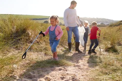 Multi-Generation Family Collecting Litter On Winter Beach Clean Up Stock Photos