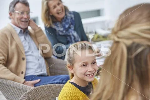 Multi-generation family enjoying patio lunch Stock Photos
