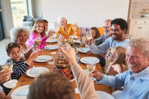 Multi-Generation Family Making A Toast With Wine As They Meet For Meal At Home Stock Photos