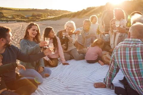 Multi-Generation Family Making A Toast With Alcohol On Winter Beach Vacation Stock Photos