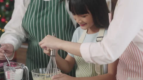 Multi-generation family preparing a bread/cake at home Stock Footage 255477930