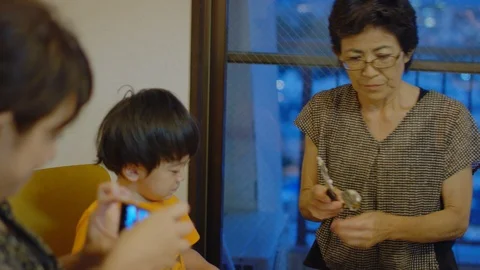 Multi-generation family serving and eating food at home. Stock Footage 100830808