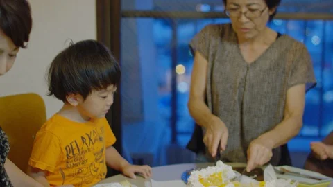 Multi-generation family serving and eating food at home. Stock Footage 100831708