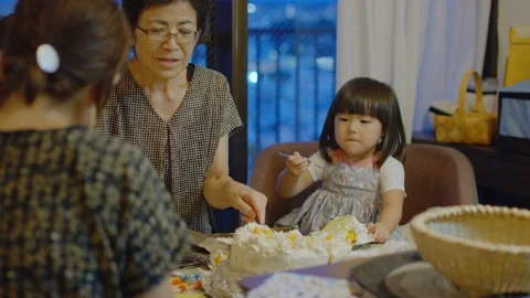 Multi-generation family serving and eating food at home. Stock Footage 100832701