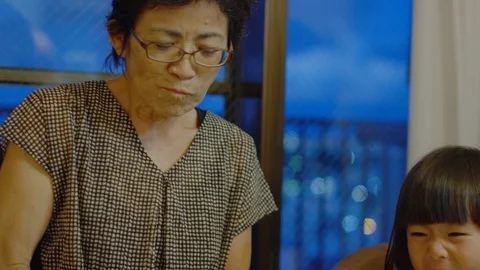 Multi-generation family serving and eating food at home. Stock Footage 100834908