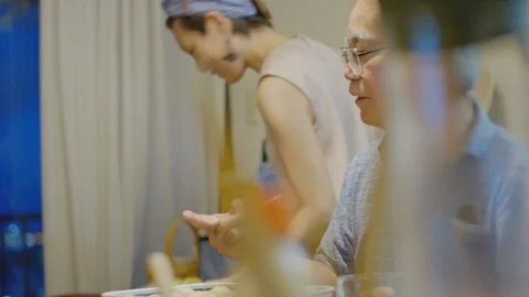 Multi-generation family serving and eating food at home. Stock Footage 100834949