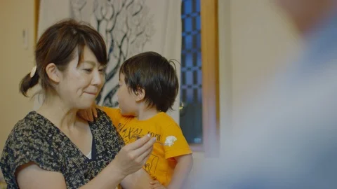 Multi-generation family serving and eating food at home. Stock Footage 100835763
