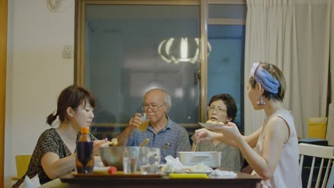 Multi-generation family serving and eating food at home. Stock Footage 100839539