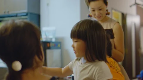 Multi-generation family serving and eating food at home. Stock Footage 100840382
