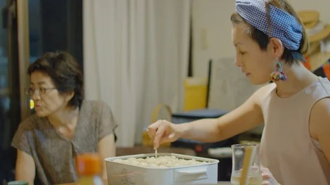 Multi-generation family serving and eating food at home. Stock Footage 100842284