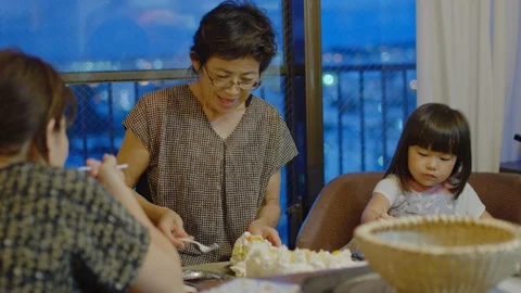Multi-generation family serving and eating food at home. Stock Footage 101001213