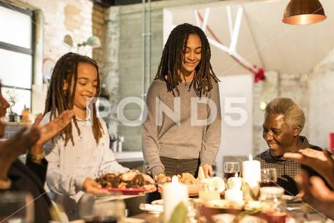 Multi-generation family serving Christmas dinner Stock Photos