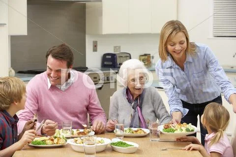 Multi-generation family sharing meal together Stock Photos