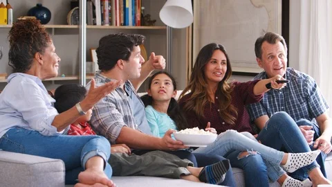 Multi Generation Family Sitting On Sofa Watching TV Together Stock-Footage 95956385