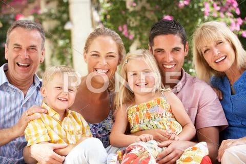 Multi generation family sitting on sofa together Stock Photos