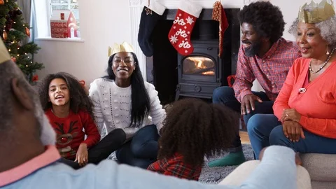 Multi Generation Family Talking And Telling Stories As They Celebrate Christmas Stock Footage