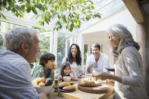 Multi-generation family talking in kitchen Stock Photos