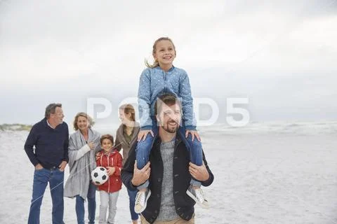 Multi-generation family walking on winter beach Stock Photos