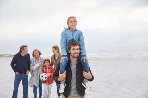 Multi-generation family walking on winter beach Stock Photos