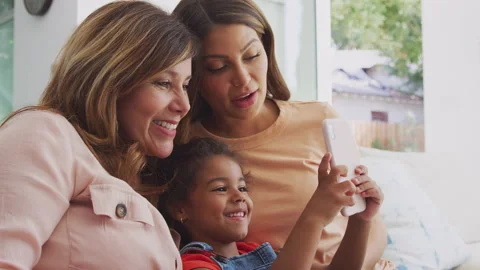 Multi-Generation Female Hispanic Family At Home Pulling Funny Faces For Selfie Stock Footage