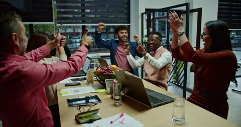 Multi generational, businesspeople collaborate in a creative office at late Stock Footage 262471989