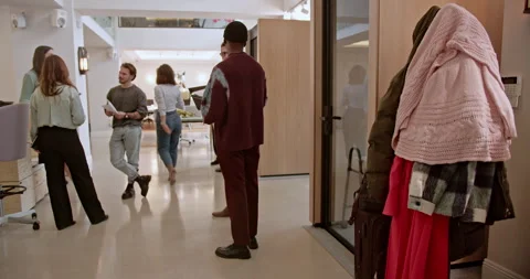 Multi generational colleagues engage in a casual business discussion in a Stock Footage 275291171