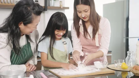 Multi-generational family baking together at home Stock Footage 255553156