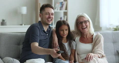 Multi generational family choose program, switch channels enjoy leisure Video stock 243454647