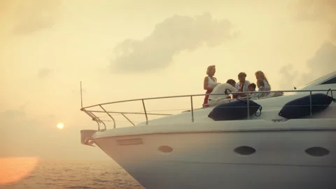 Multi generational family making a toast on a stunning yacht as the sun sets Video stock 323250955