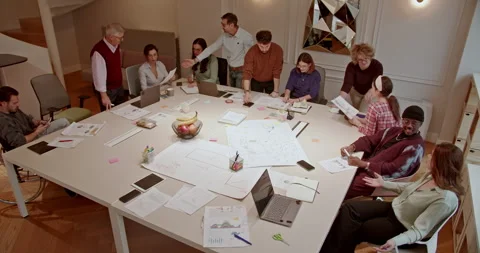 Multi generational group of business professionals engaged in brainstorming Stock Footage 275297196