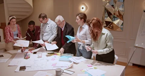 A multi generational group of entrepreneurs engage in a collaborative meeting Stock Footage 273501528