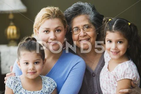 Multi-generational Hispanic family hugging Stock Photos