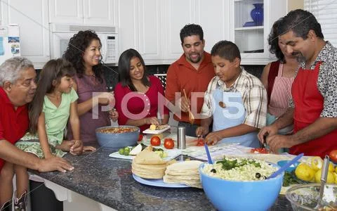 Multi-generational Hispanic family preparing food Stock Photos
