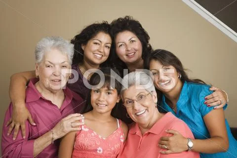 Multi-generational Hispanic female family members smiling posing Stock Photos