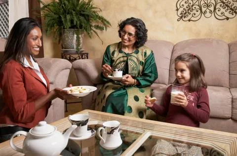 Multi-generational Indian female family members having snack Stock Photos