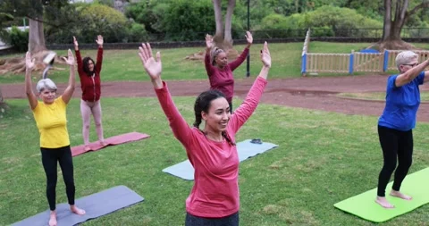 Multi generational people doing yoga class at city park Stock Footage 151682351