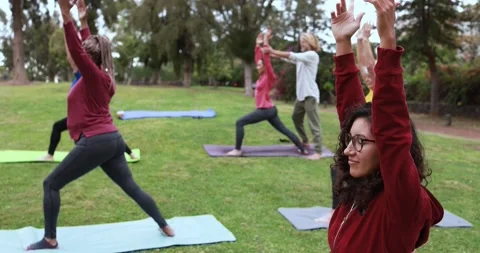 Multi generational people doing yoga class at city park Видео 151682435